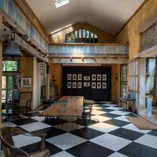 A Bawa interior with a checkerboard floor and long table